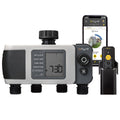 Dual-outlet digital hose timer beside phone and remote.