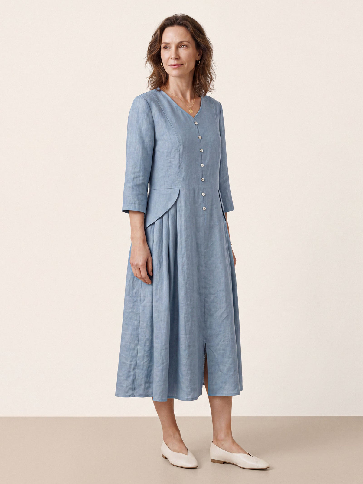 Front view of a light blue V-neck midi dress with three-quarter sleeves.