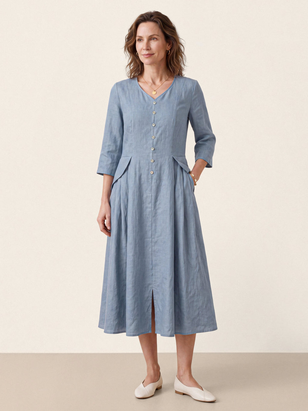 Front view of a light blue V-neck midi dress with three-quarter sleeves and buttons.