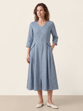 Front view of a light blue V-neck midi dress with three-quarter sleeves and buttons.