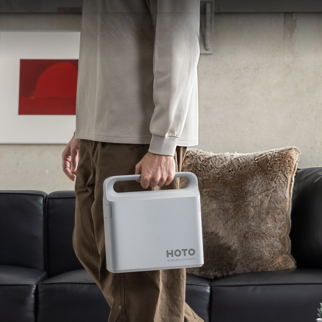Person carrying gray tool case.