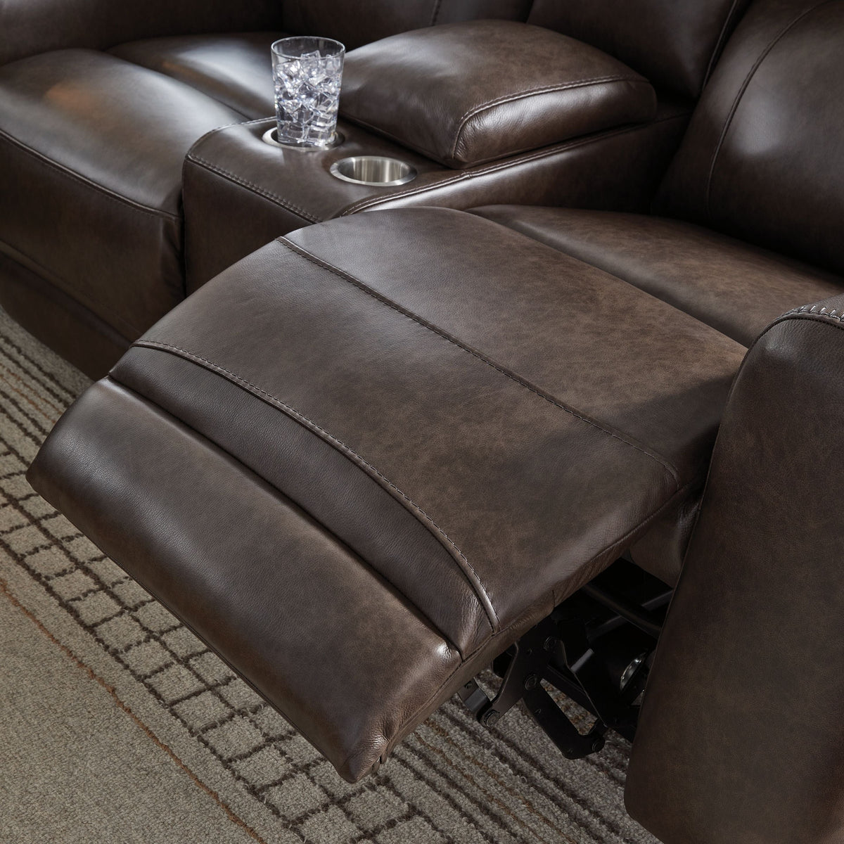 Close-up of brown recliner footrest and seat.
