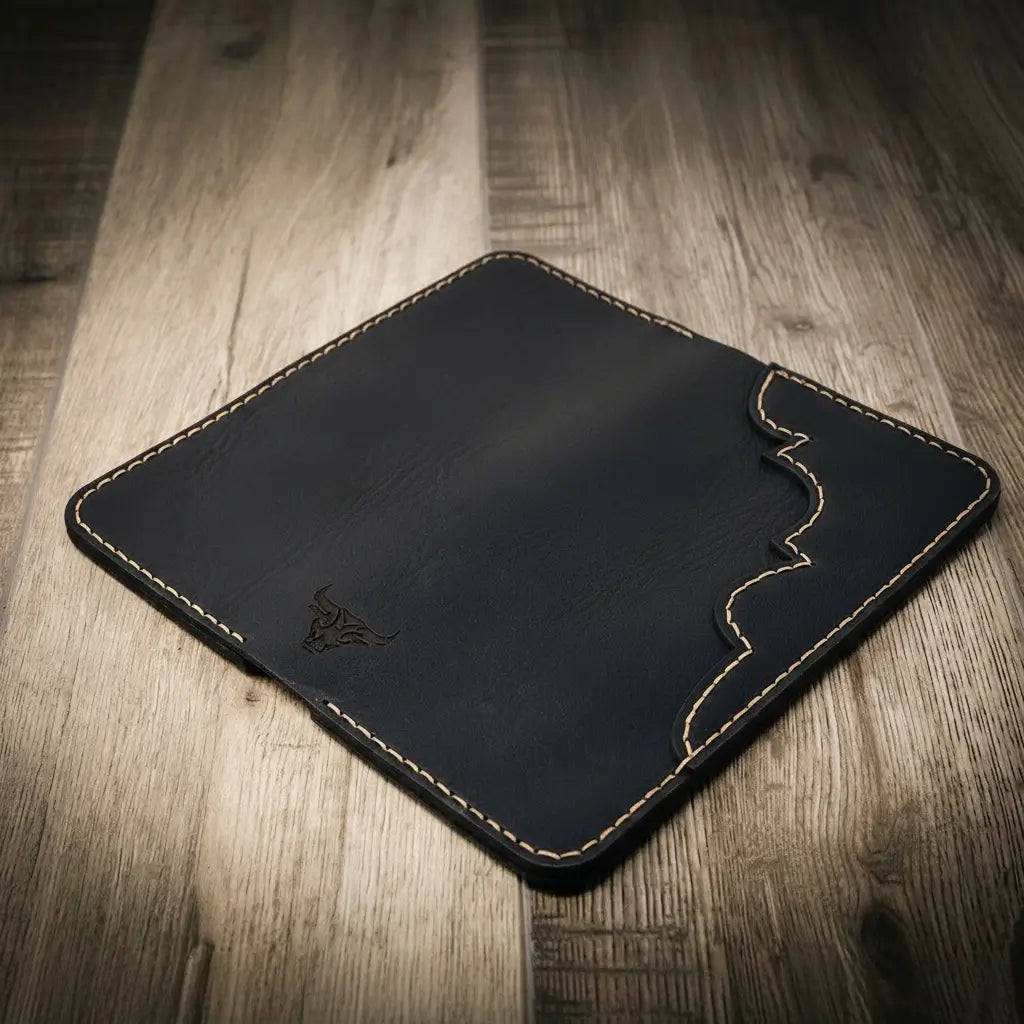 Closed black wallet with wavy stitched edge.