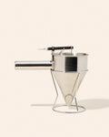 Metal pouring funnel on wire stand.