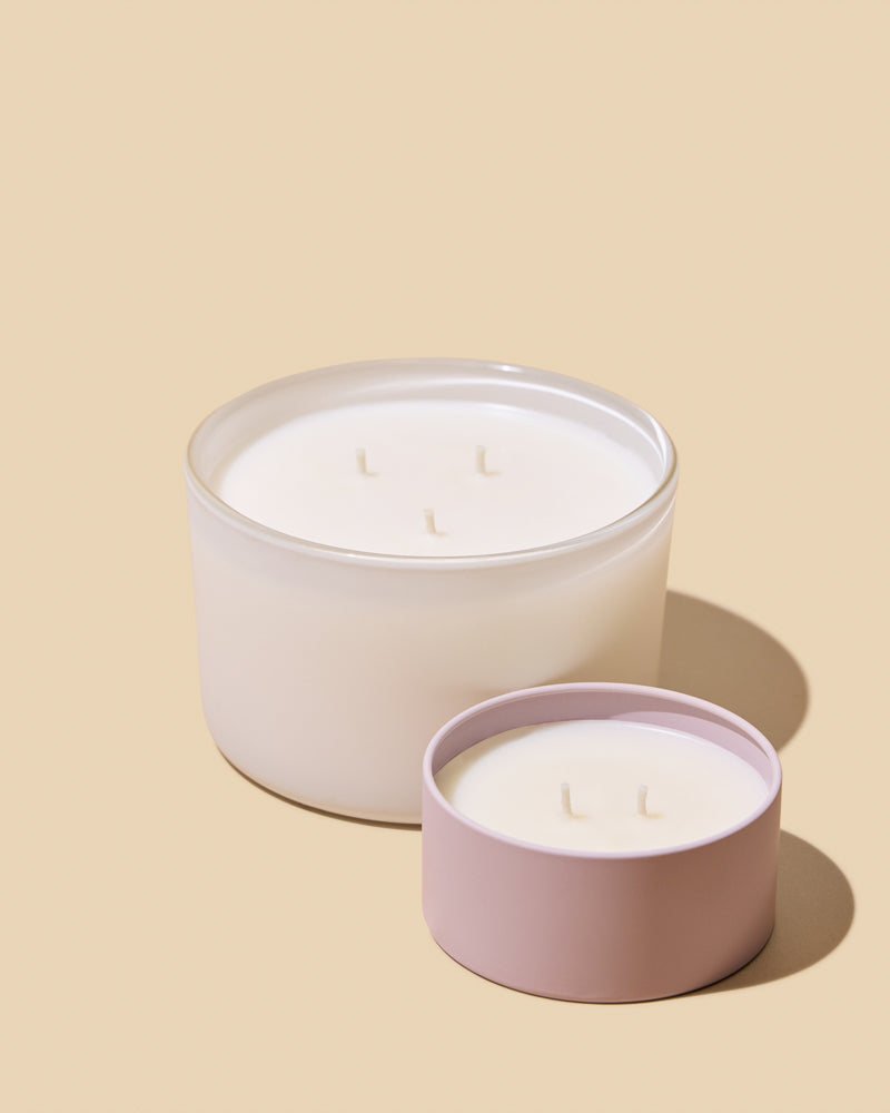 Two round pale candle tins.