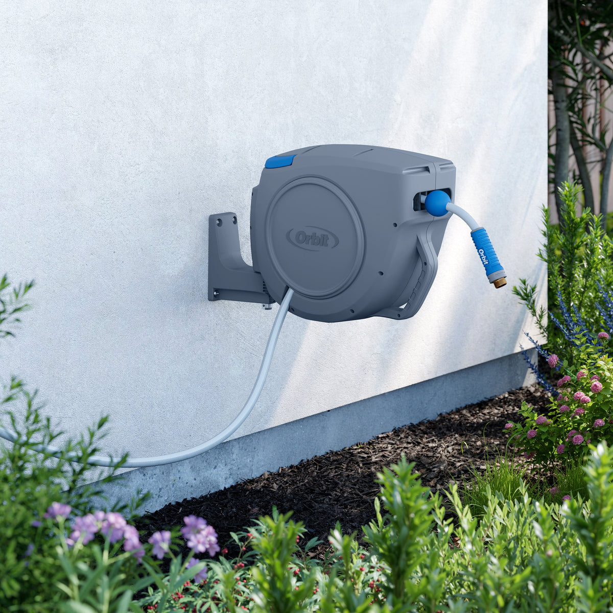 Hose reel mounted on white siding.