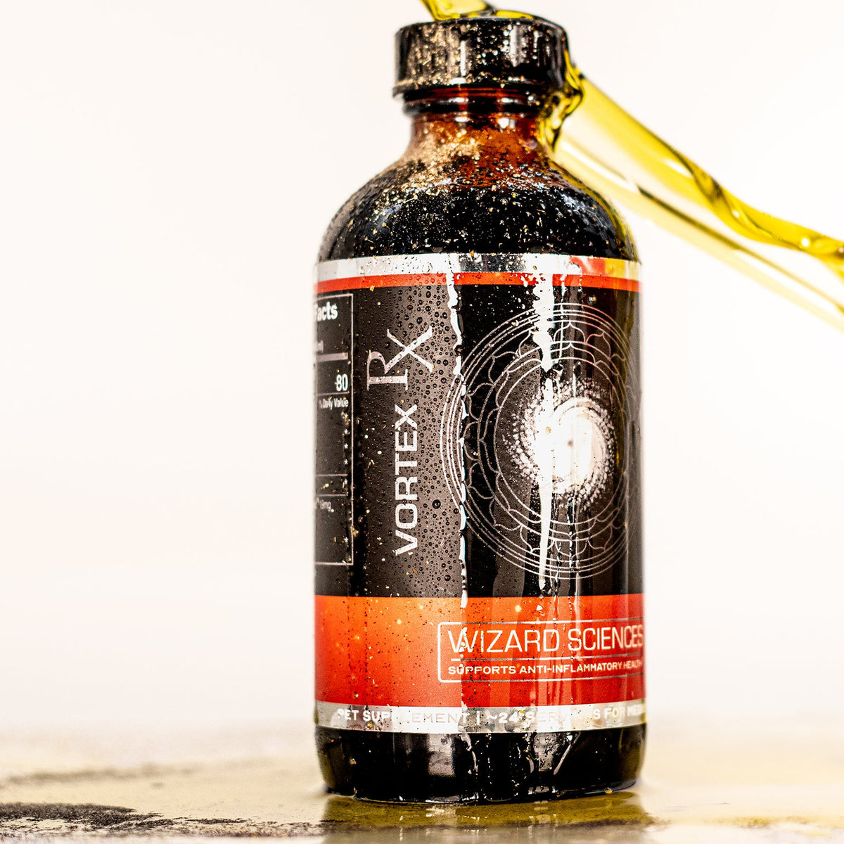 Amber bottle with orange label beside yellow liquid.