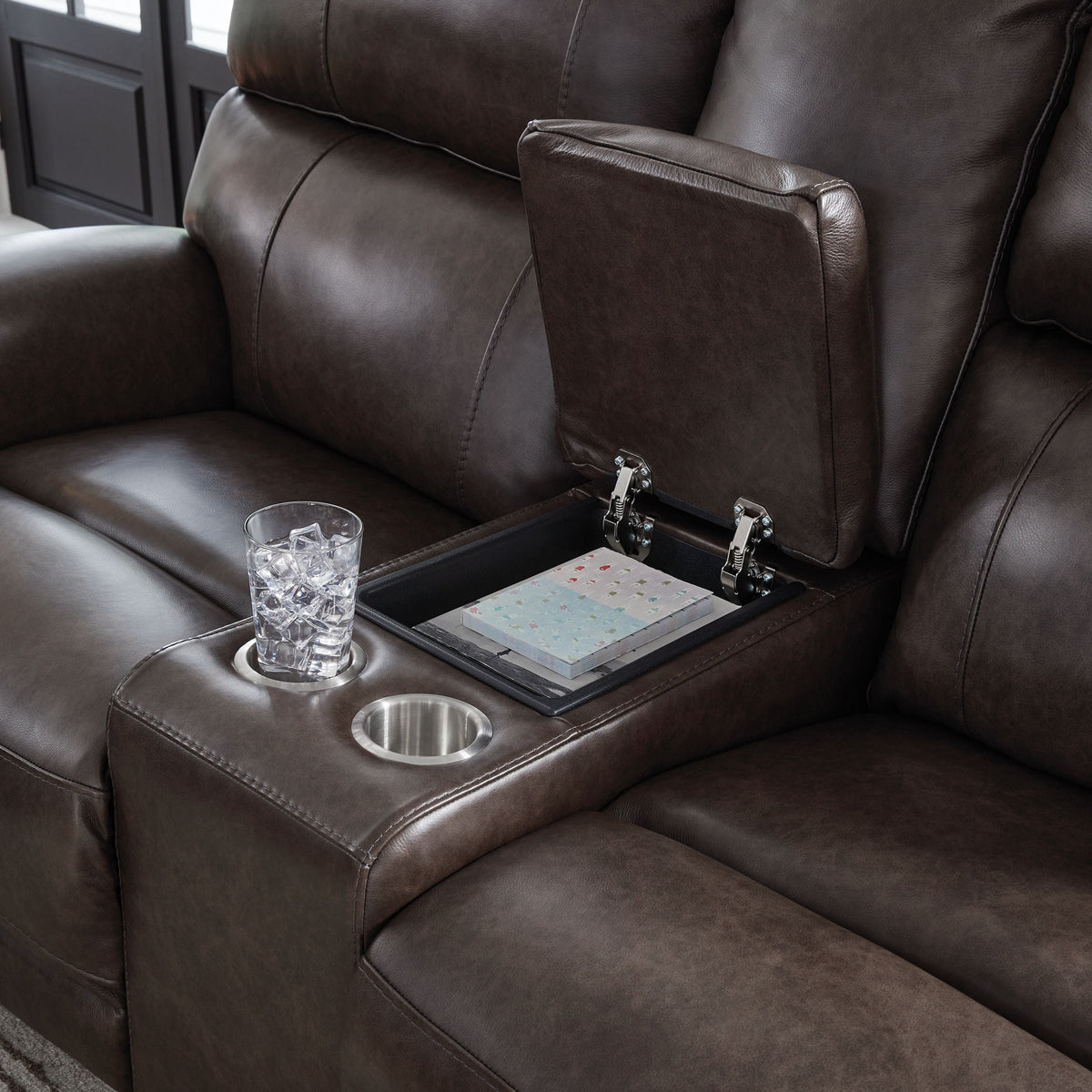 Close-up of sofa armrest storage with cupholders.