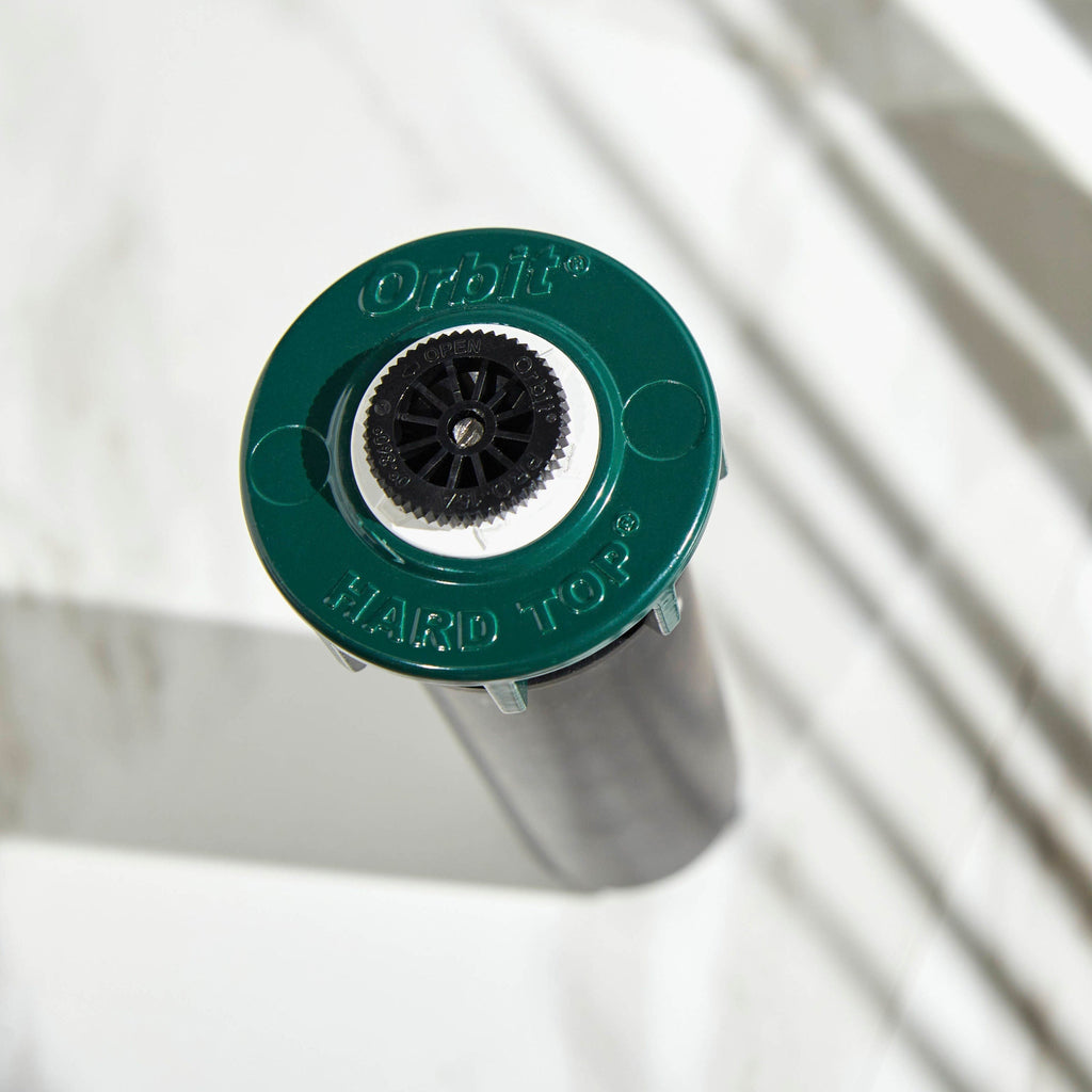 Close-up of sprinkler top and green collar.