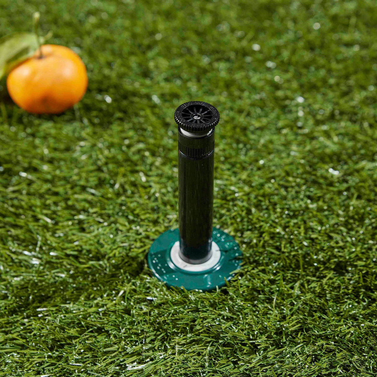 Pop-up sprinkler installed in grass.