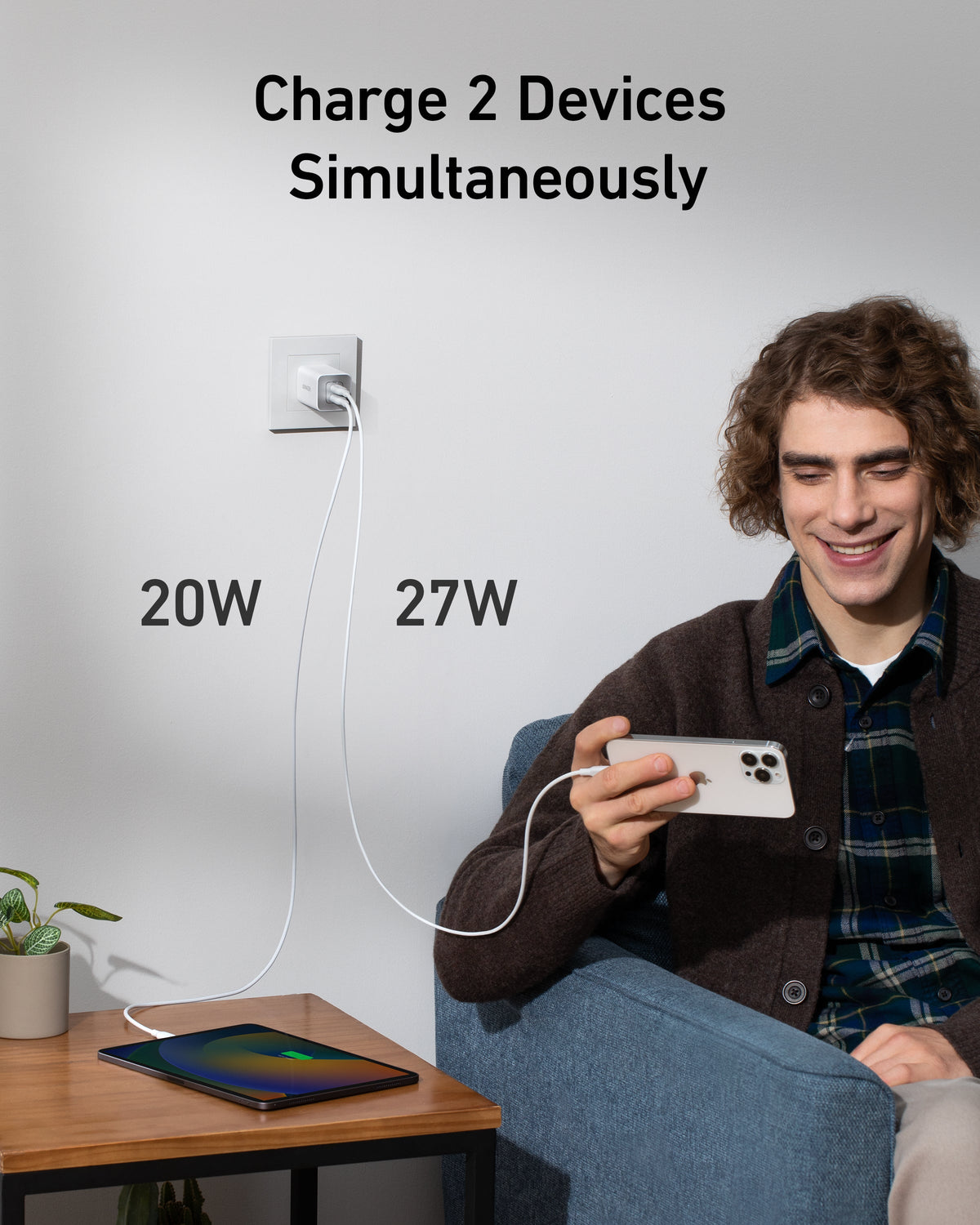 White wall charger charging two devices.