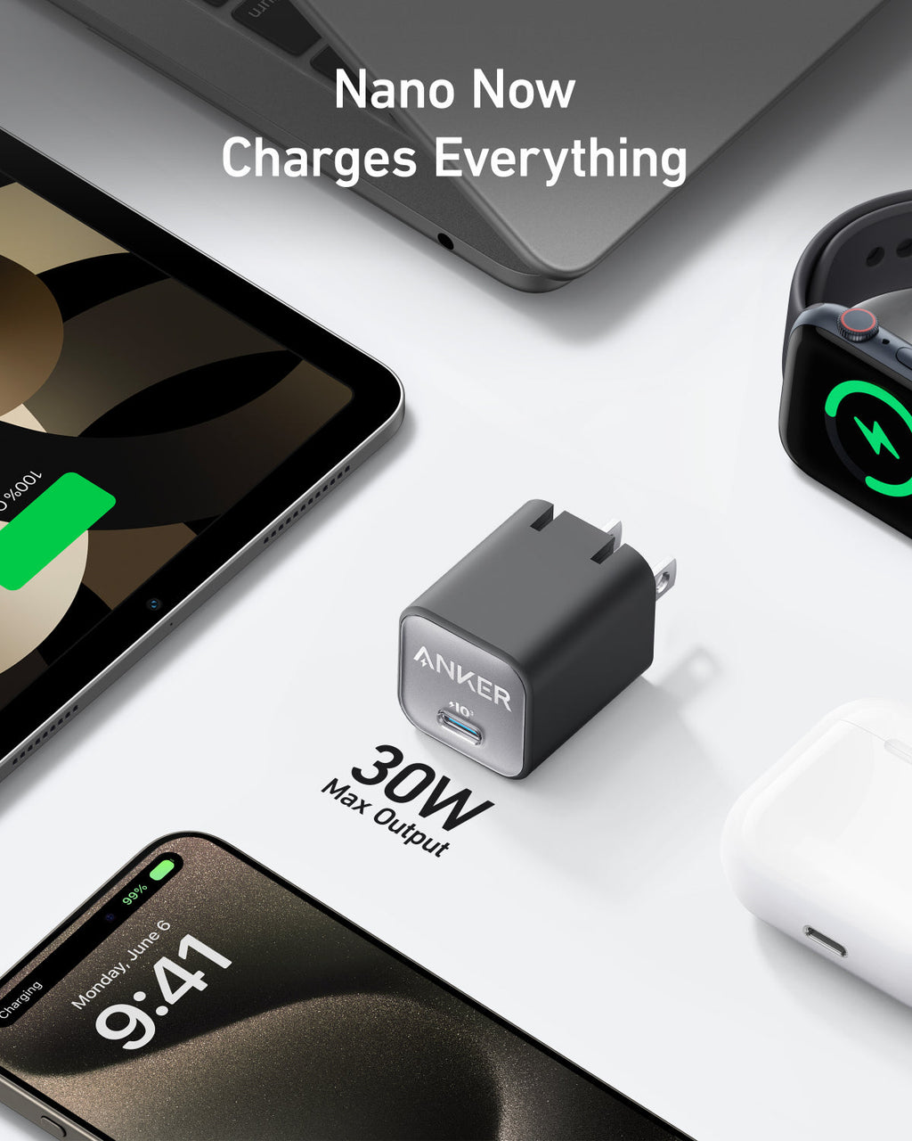 Compact charger beside laptop.