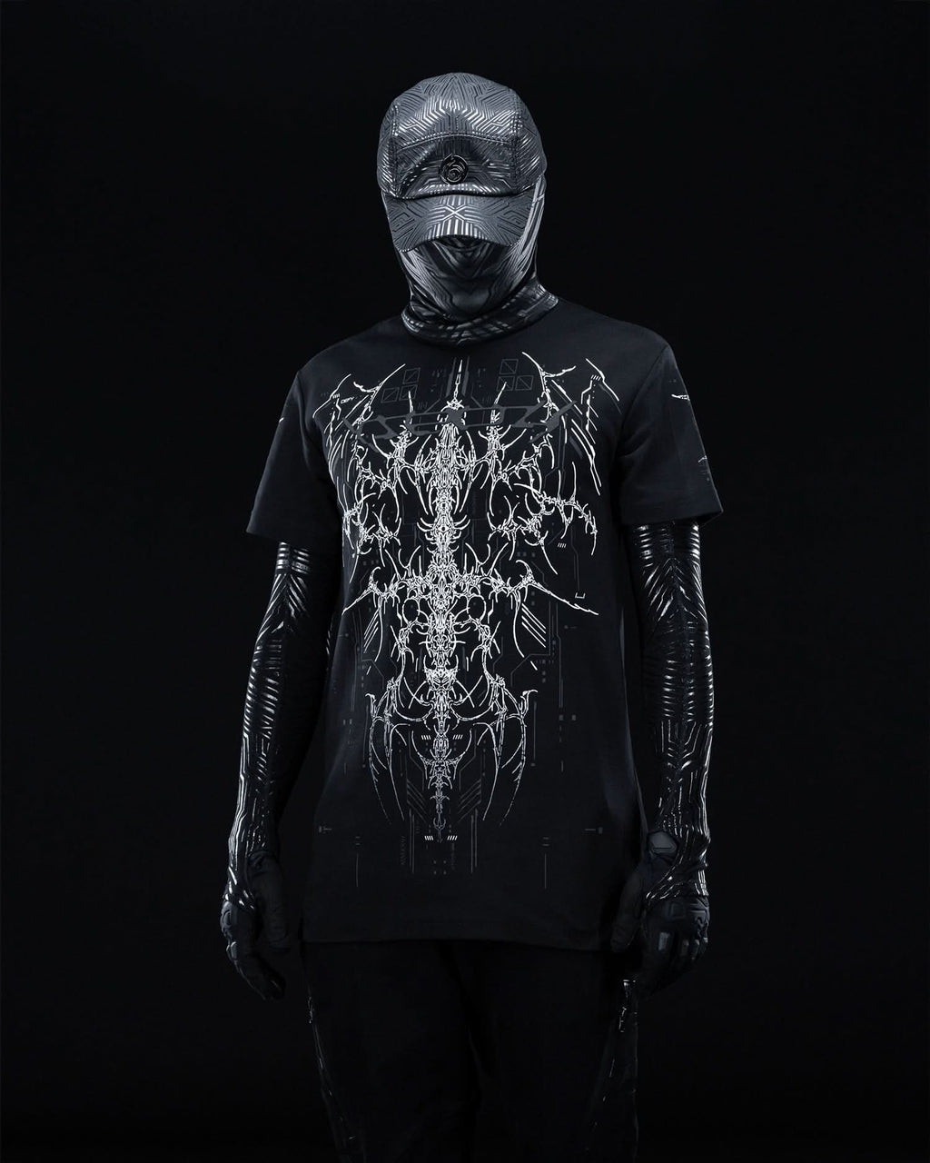 Front view of masked model wearing black T-shirt with fine gray ornamental artwork.