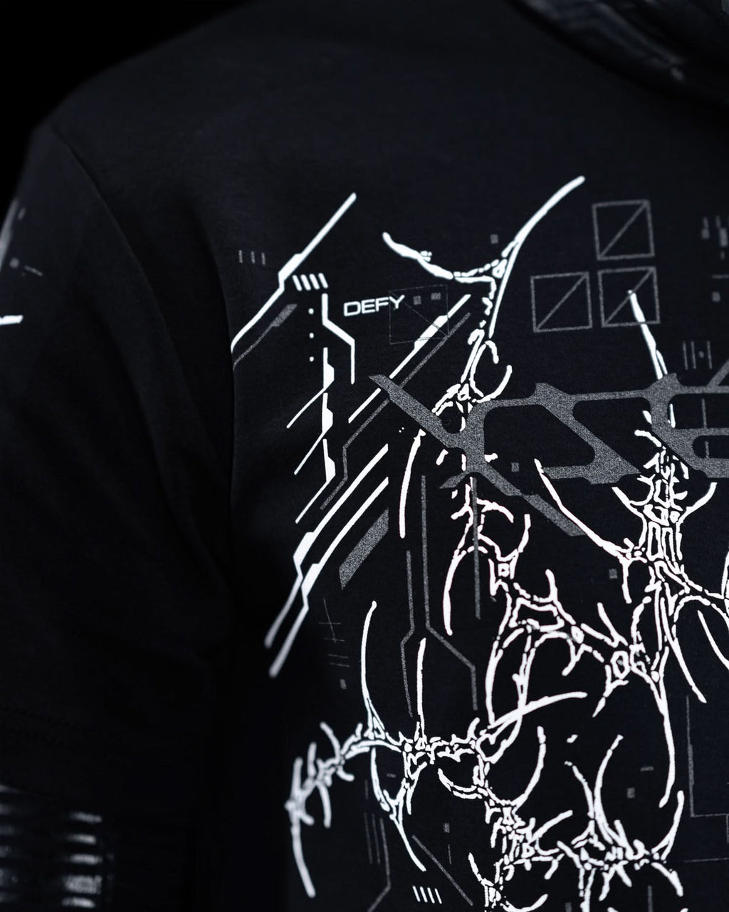 Close-up of shoulder artwork on black T-shirt with gray ornamental graphics.