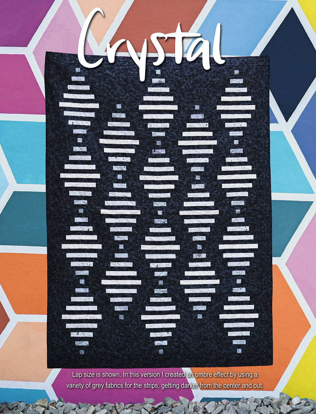 Dark quilt labeled Crystal with white geometric rows.