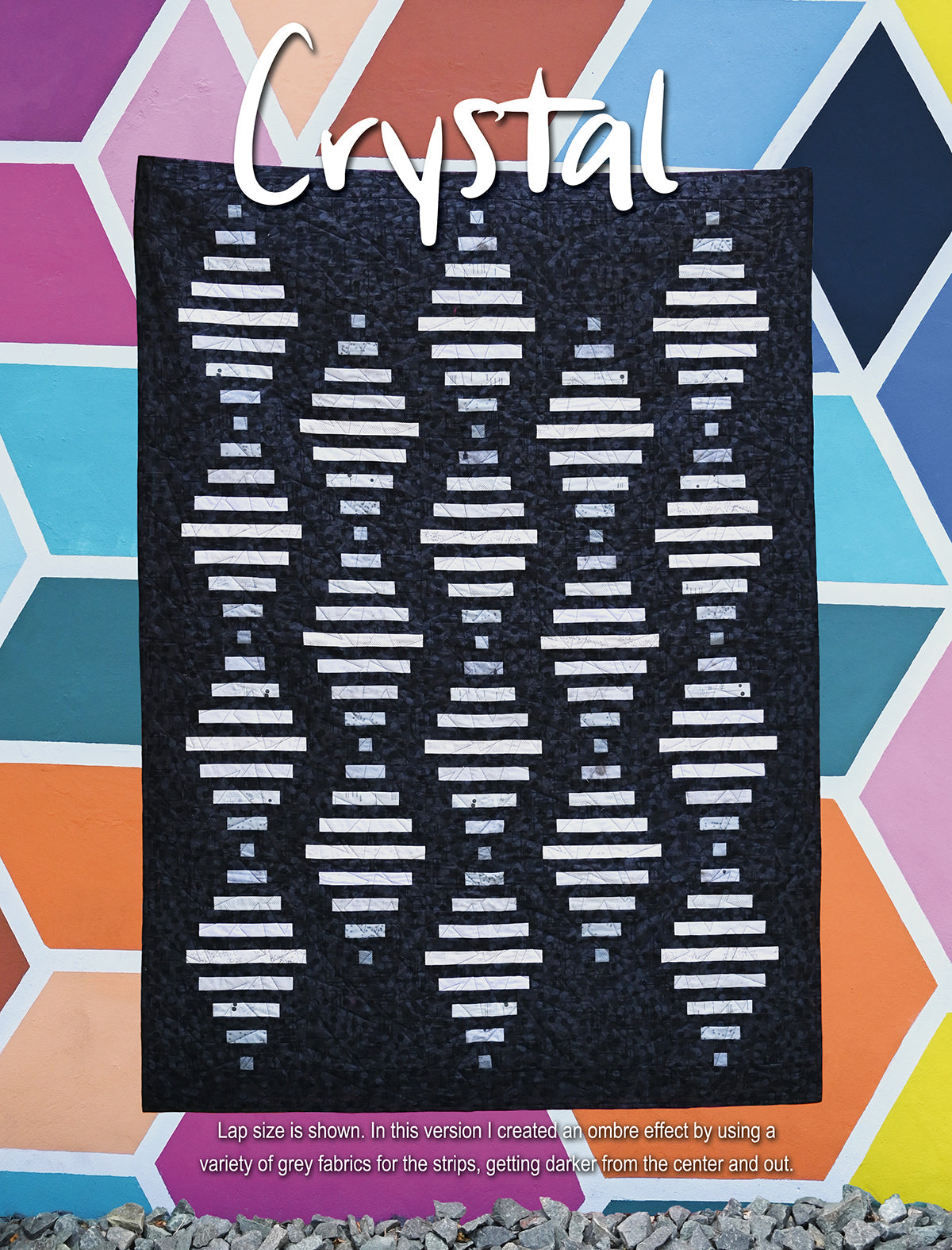 Dark quilt labeled Crystal with white geometric rows.