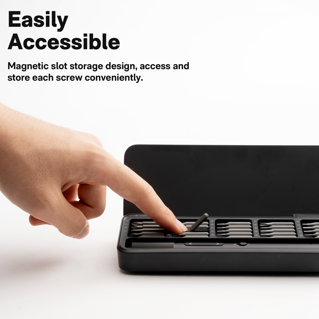 Hand accessing precision screwdriver bit tray.