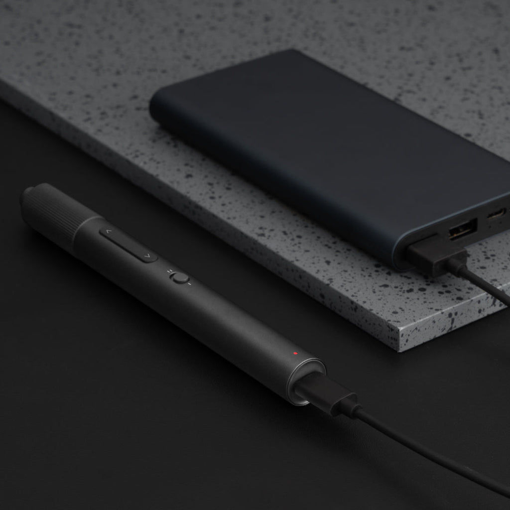 Precision screwdriver beside black case.
