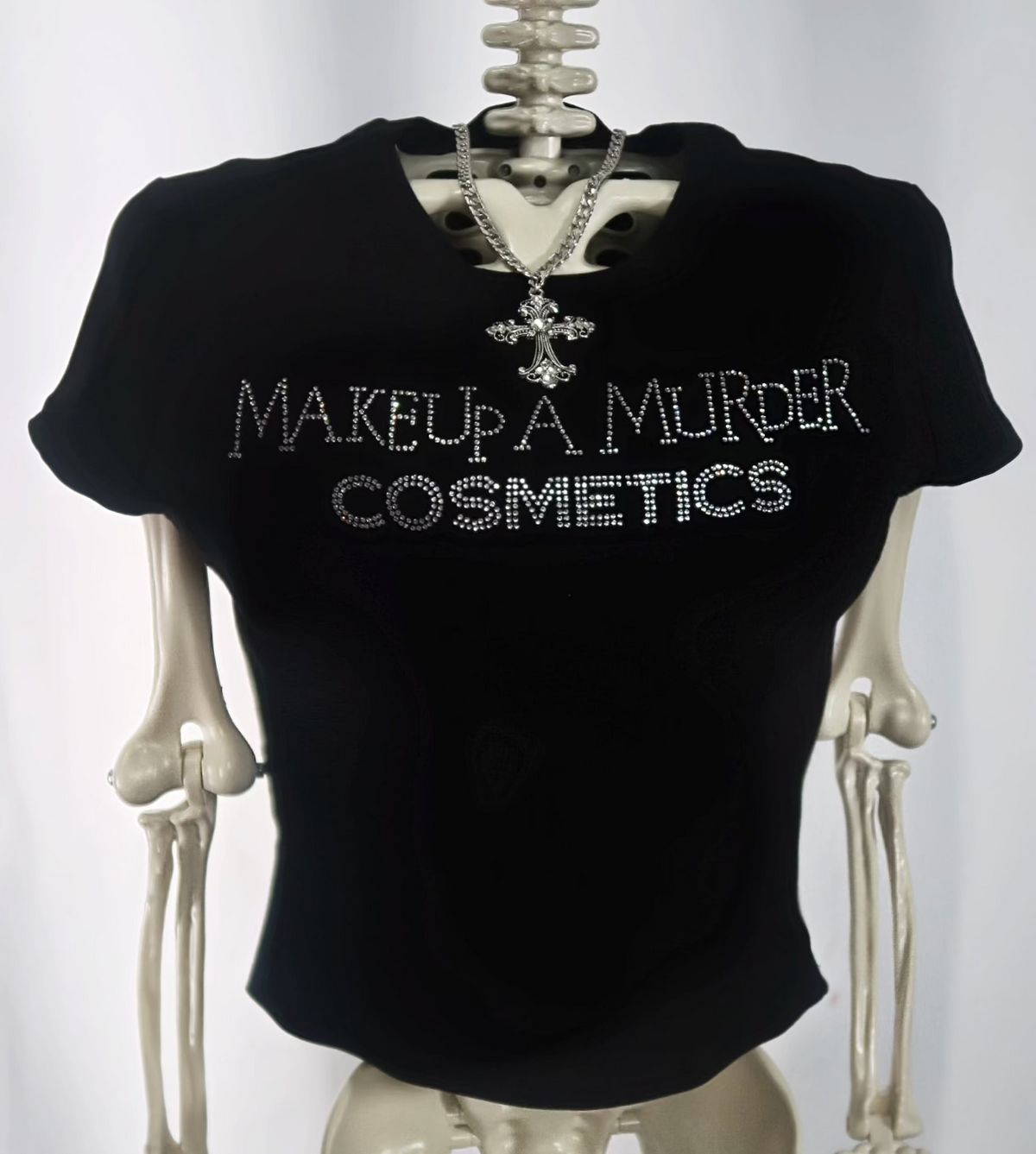 Black cropped T-shirt on mannequin with cosmetics lettering.