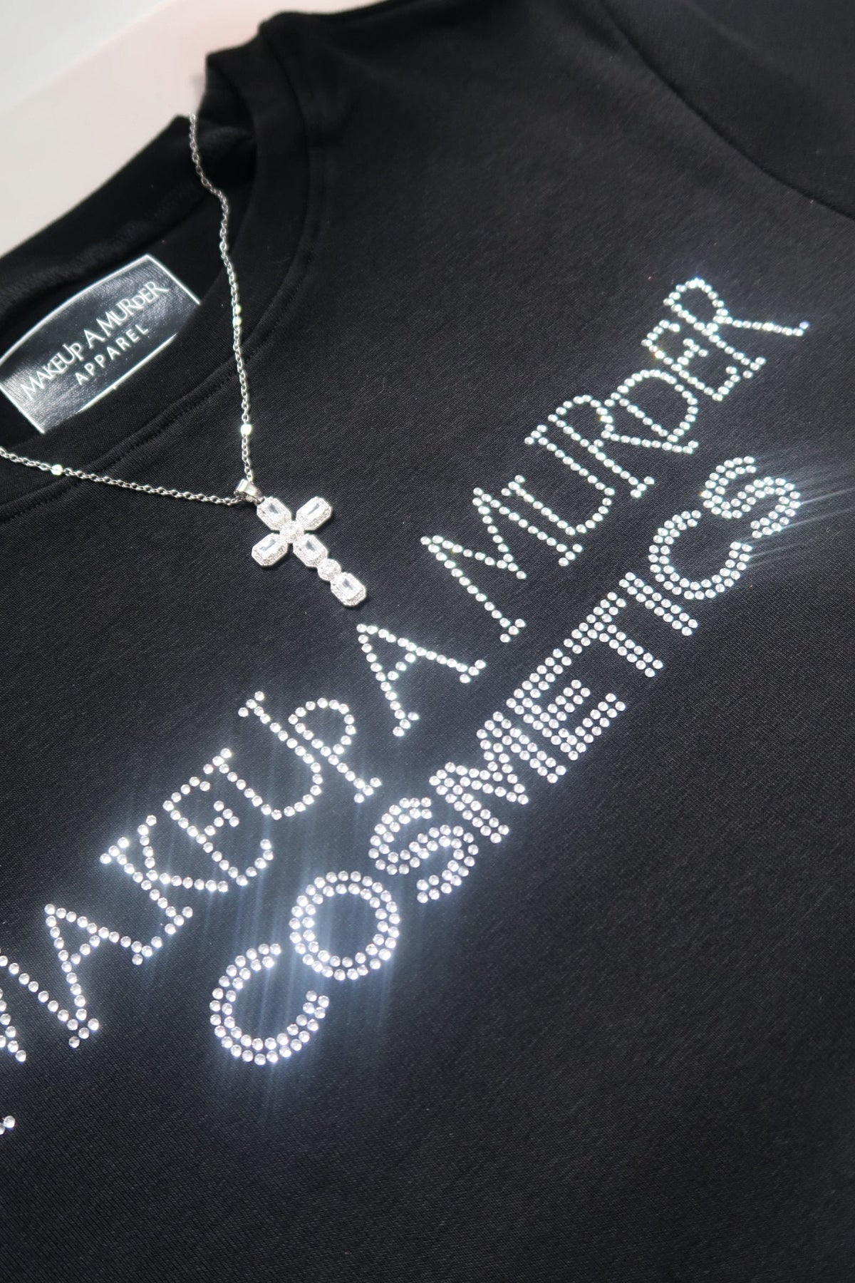 Close-up of lettering on black cosmetics T-shirt.