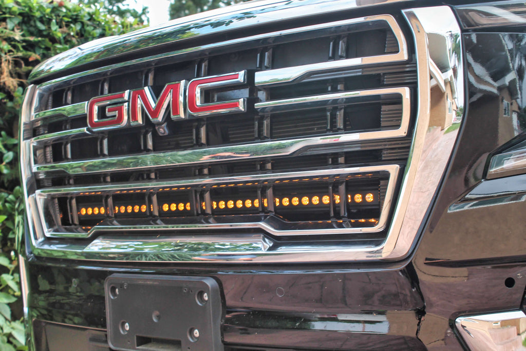 Close-up of GMC grille with installed LED light bar.