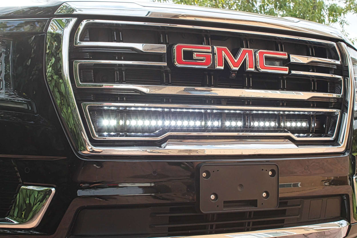 Close-up of GMC grille with installed LED light bar.