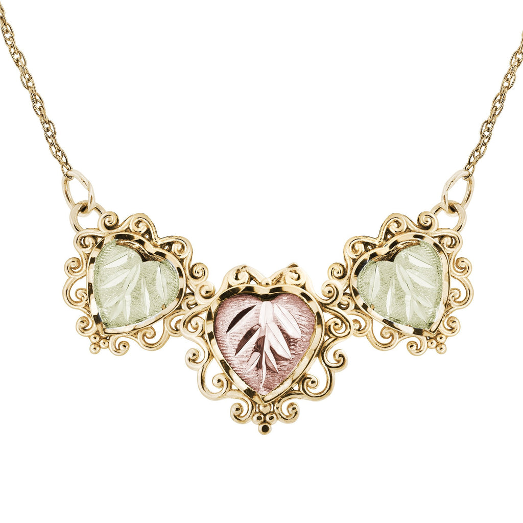 Gold-colored necklace with pink and green leaf pendants.