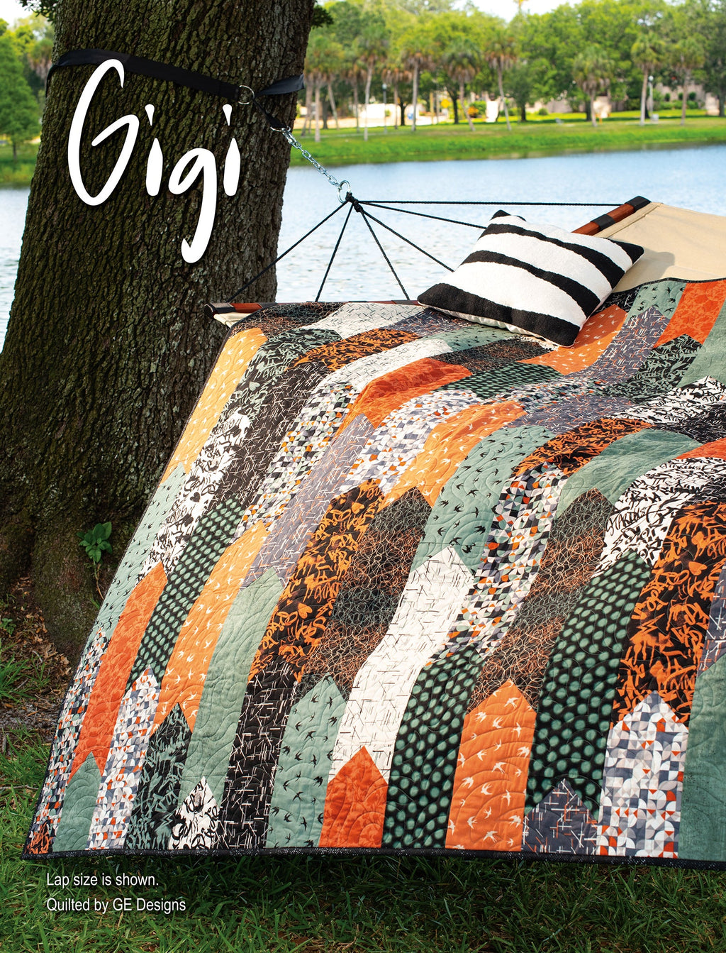Orange and gray quilt labeled Gigi over a chair.