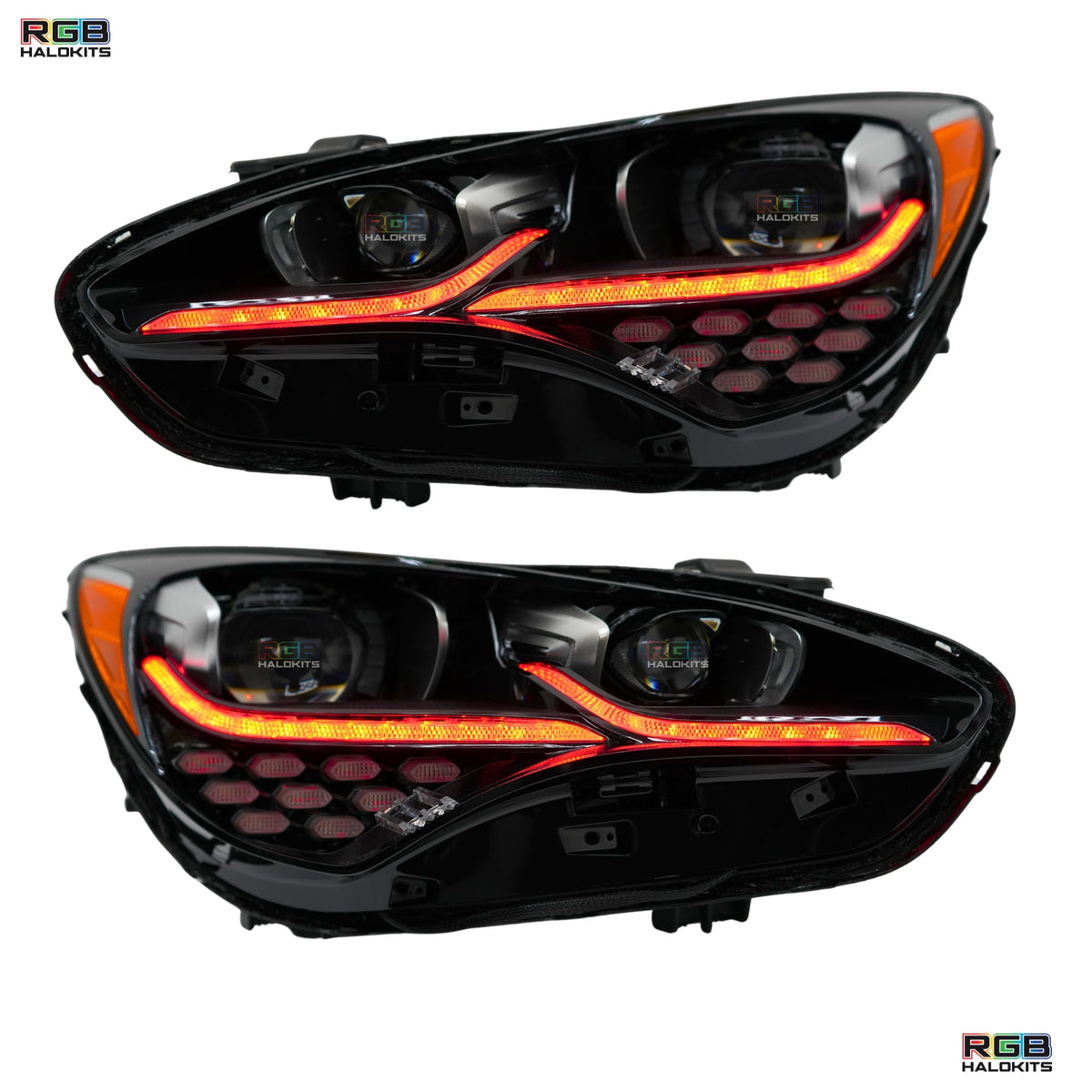 Pair of headlights with orange illuminated strips and rings.