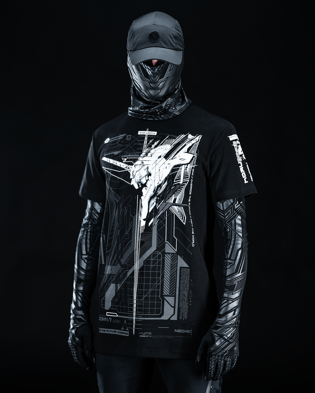 Front view of masked model wearing black T-shirt with gray technical artwork.