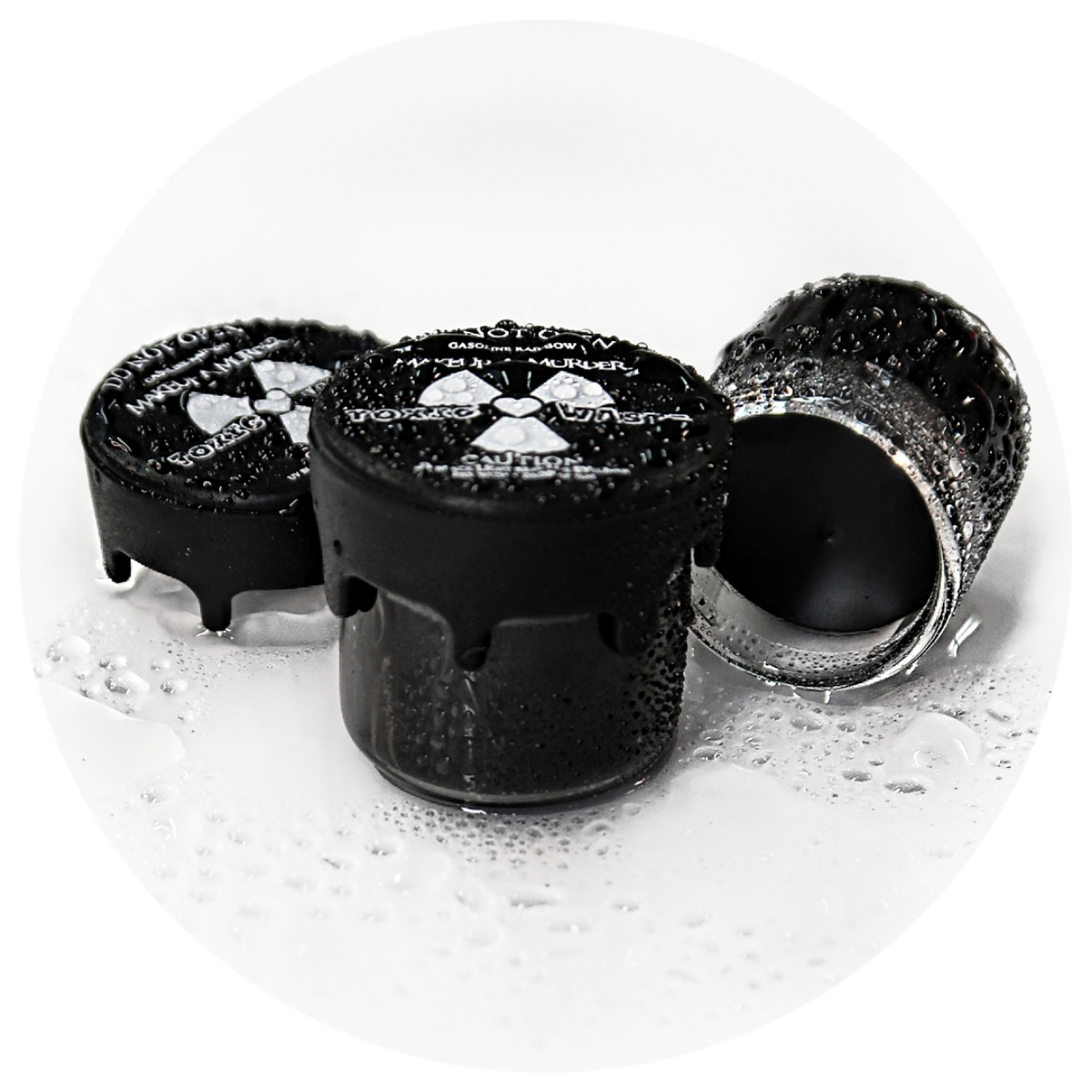 Black cosmetic pots with radiation-symbol lids.