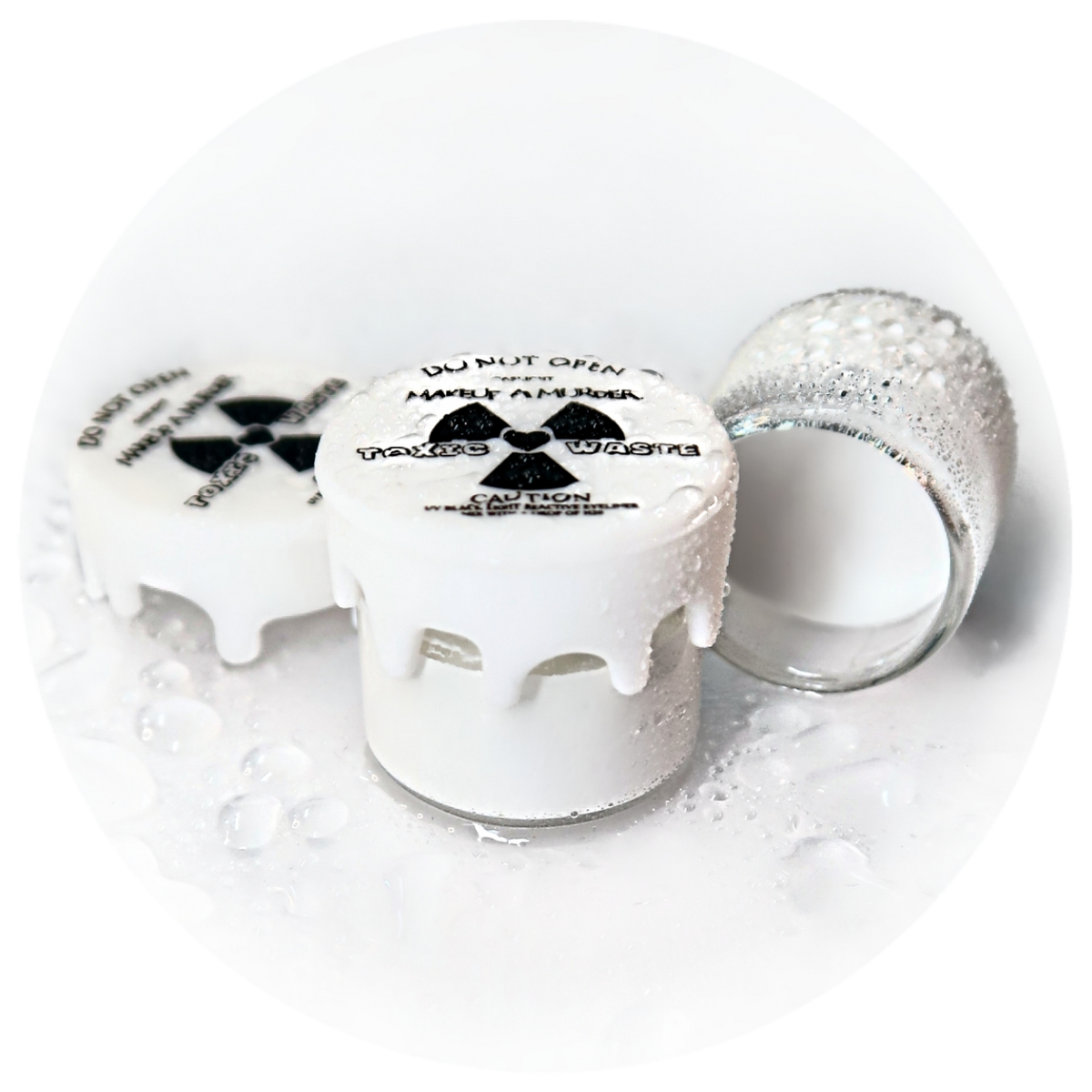 White cosmetic pots with radiation-symbol lids.