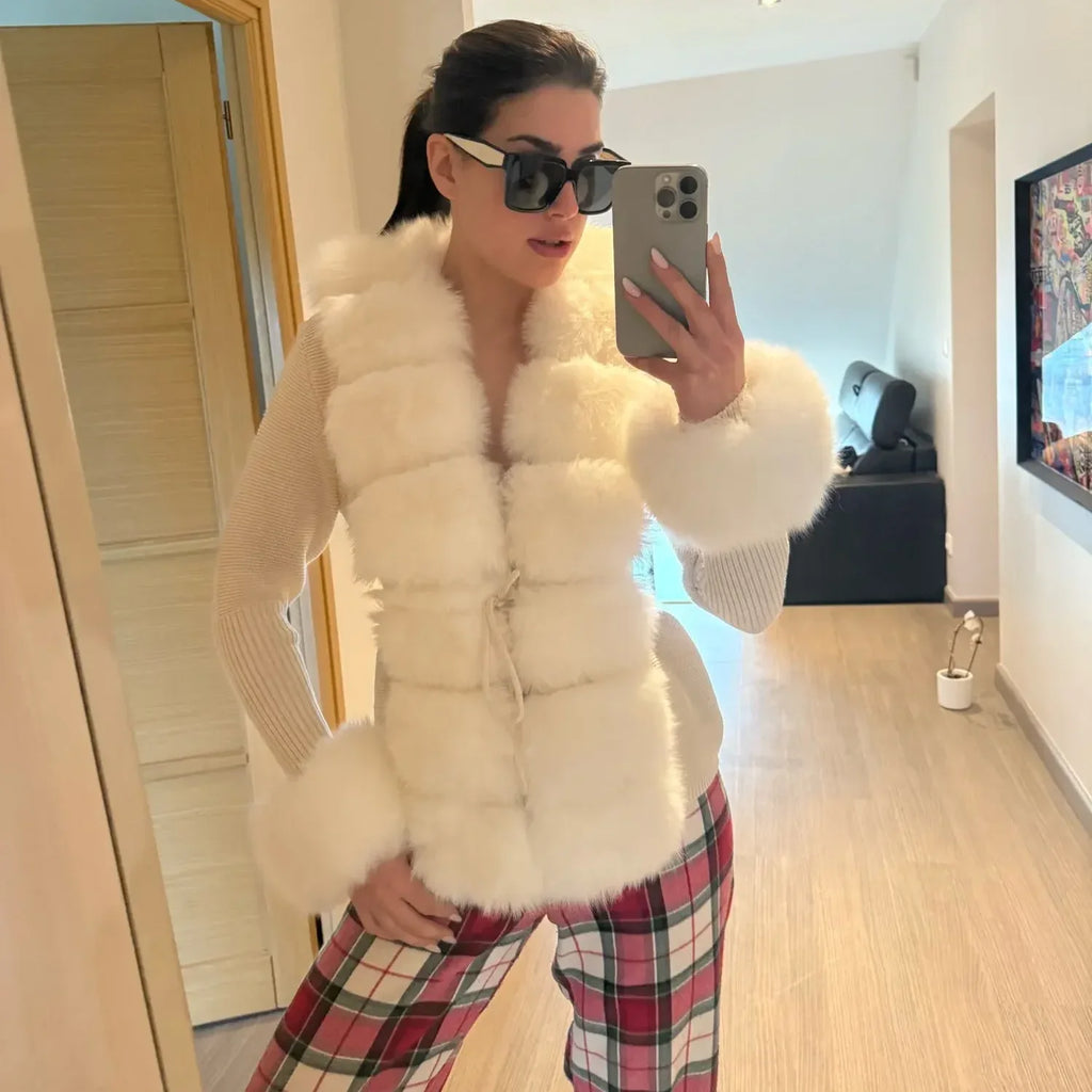 Person wearing short cream fluffy vest.