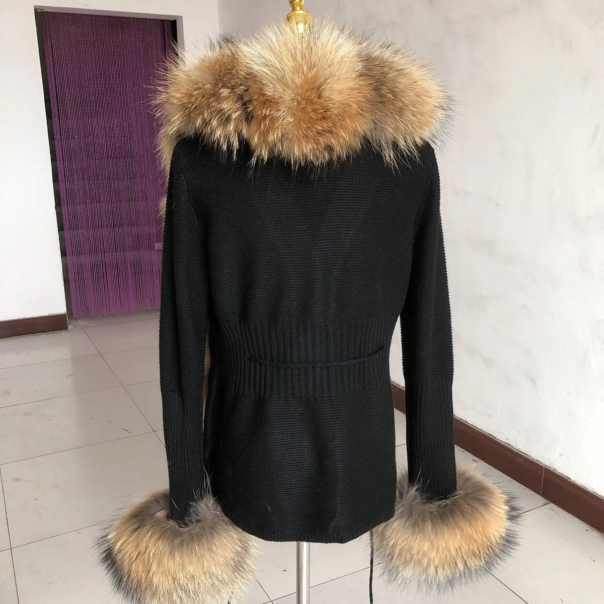 Black garment with fluffy collar and hem.