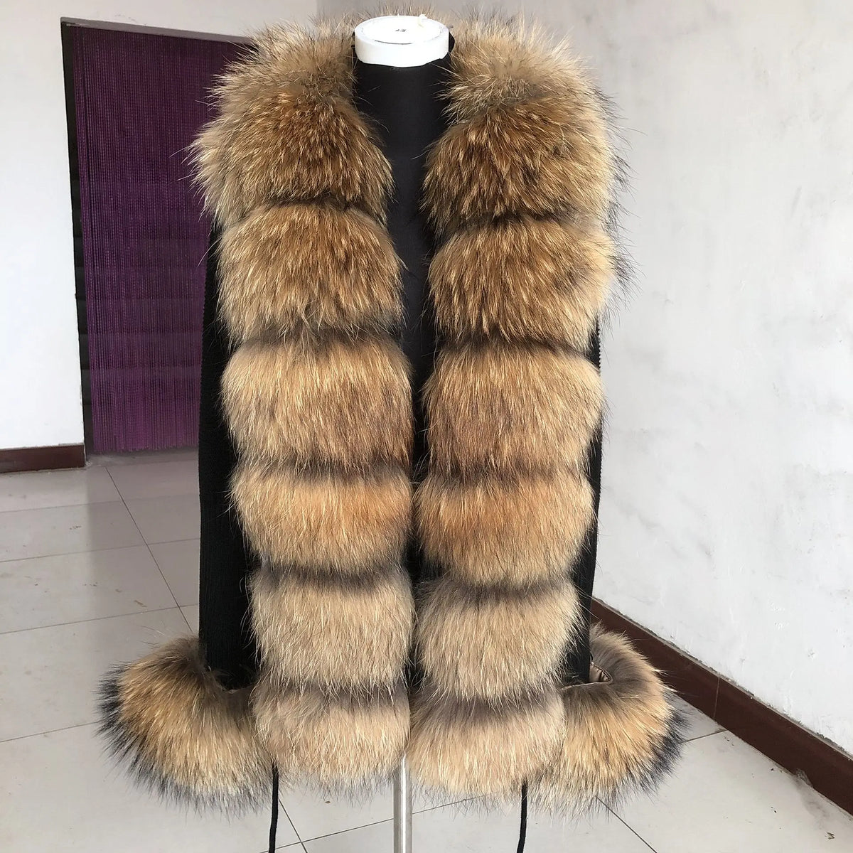 Long tan fluffy vest on mannequin.