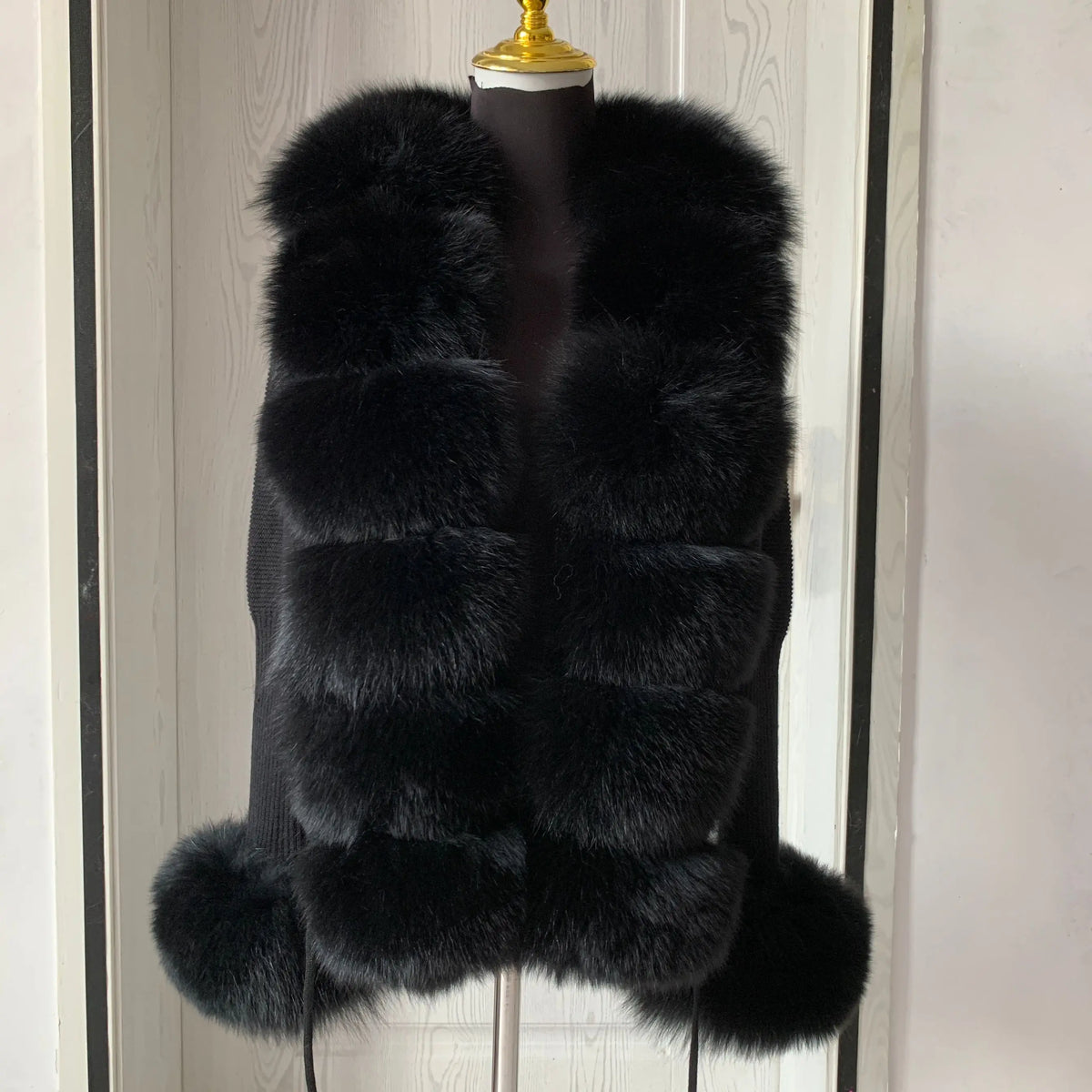 Long black fluffy vest.