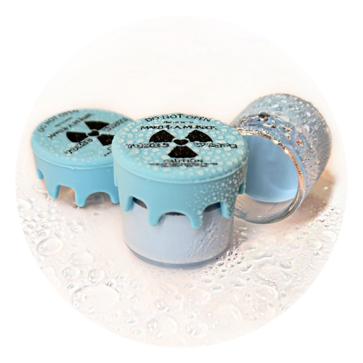 Light blue cosmetic pots with radiation-symbol lids.
