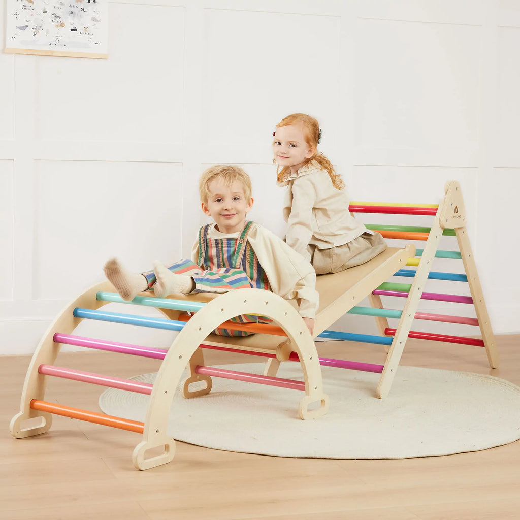 Children playing on a colorful climbing arch and triangle.