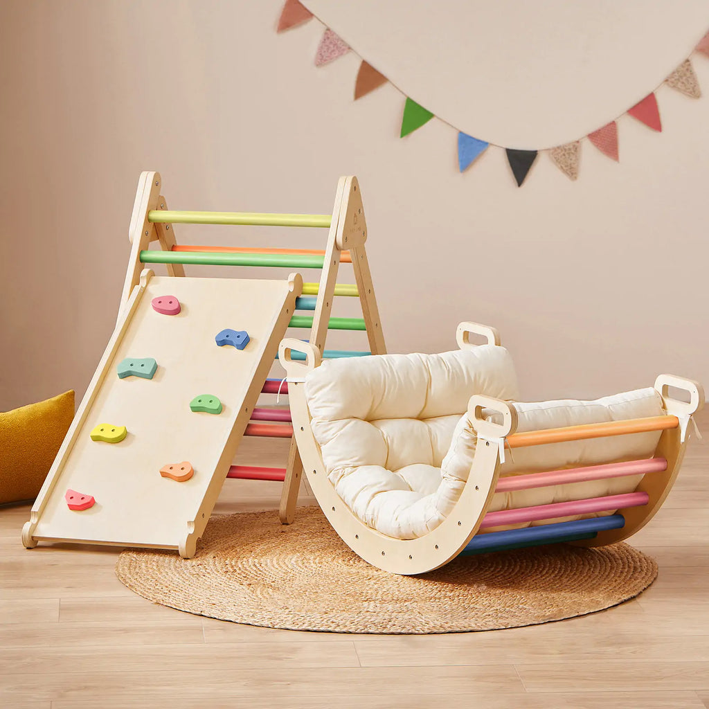 Colorful climbing triangle beside a padded climbing arch.