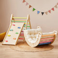 Colorful climbing triangle beside a padded climbing arch.