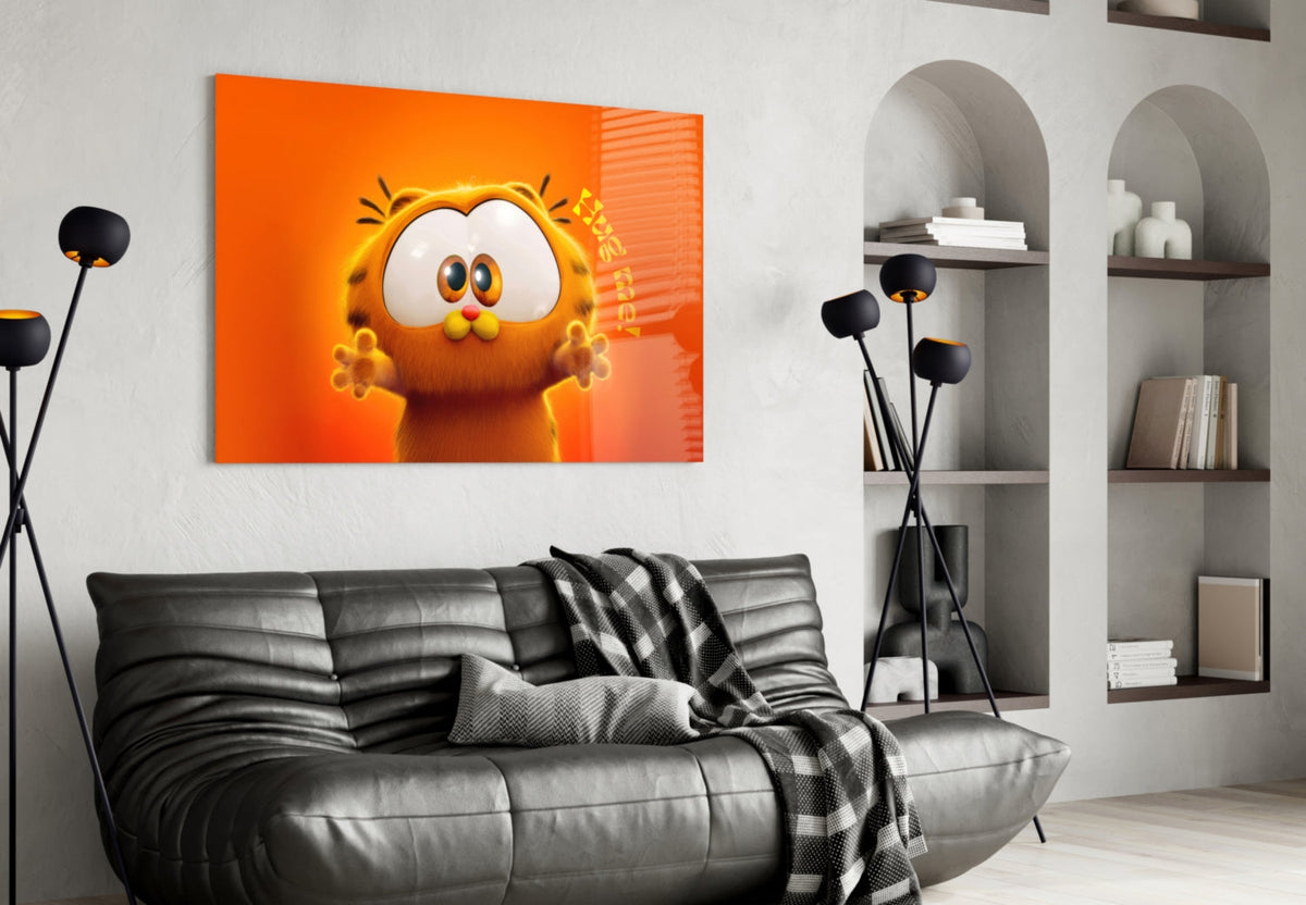 Wall art depicting Garfield's face on an orange background above a black leather sofa.