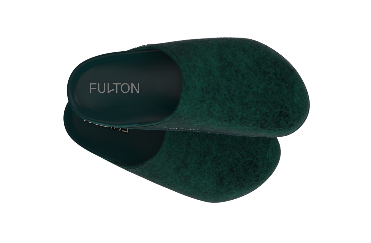 Green house slippers on black background.
