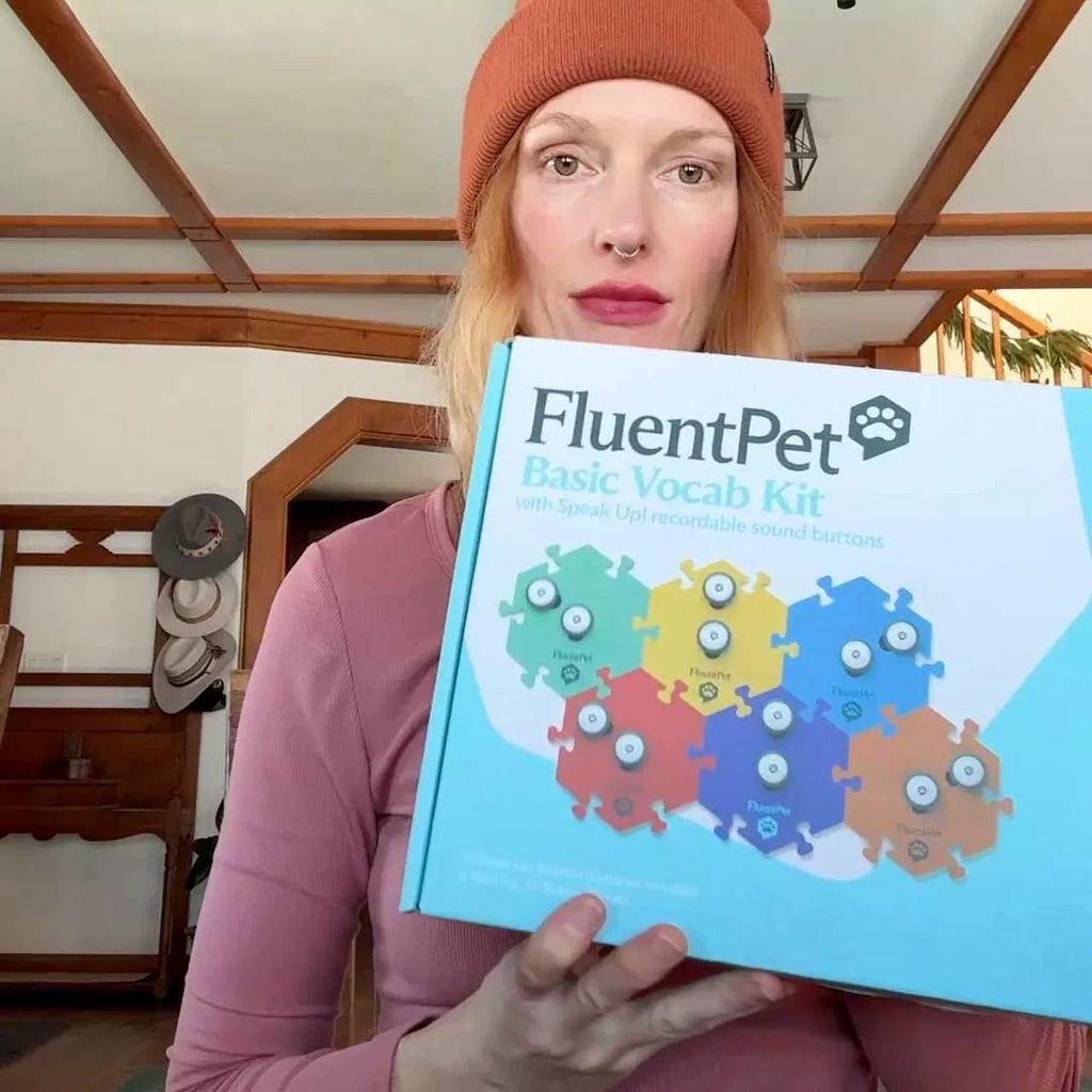 Woman holding pet communication kit.