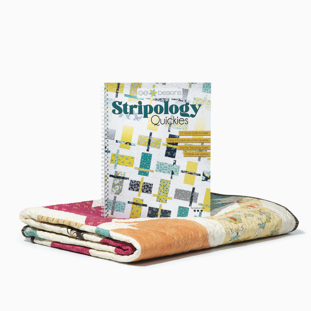 Stripology Quickies book beside folded quilts.